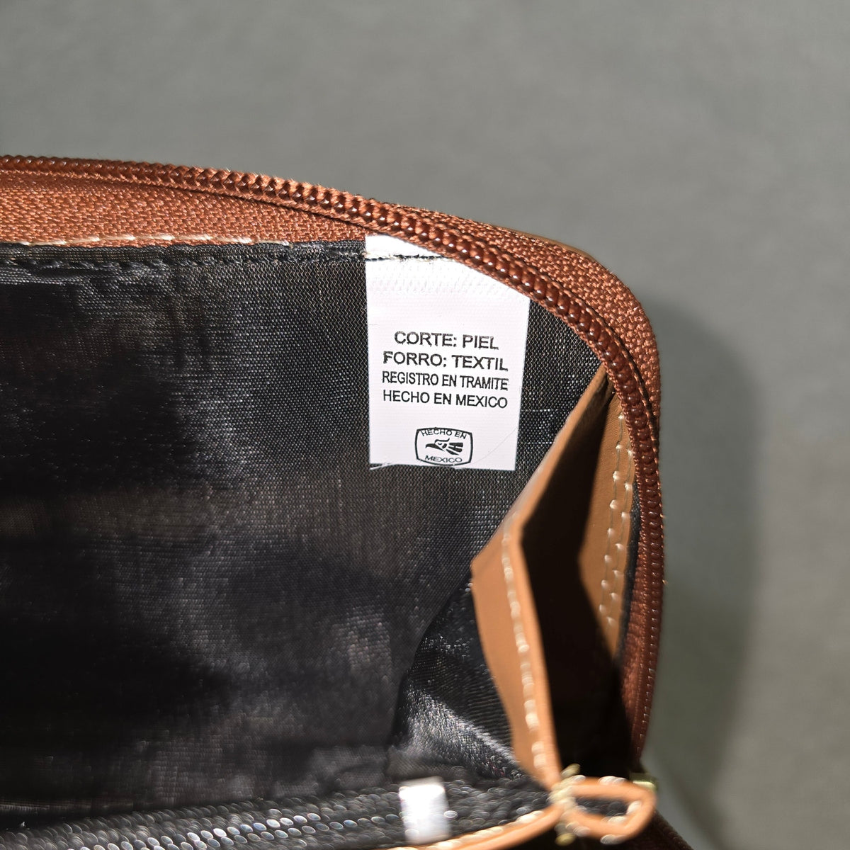 Close-up of a leather wallet with a label