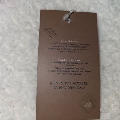 Brown product tag with text on a textured surface